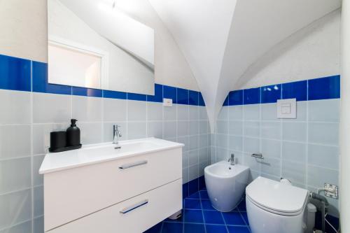a bathroom with a white sink and a toilet at Comfort Zone - Amalfi Coast in Maiori
