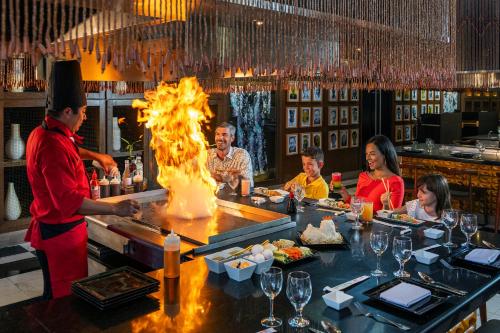 a group of people sitting at a bar in a restaurant at Ocean Riviera Paradise All Inclusive in Playa del Carmen