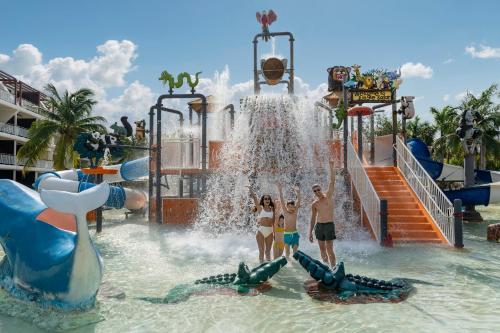 a group of people standing in the water at a water park at Ocean Riviera Paradise All Inclusive in Playa del Carmen