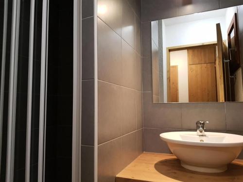 a bathroom with a sink and a mirror at Résidence Roc Belleface C - Appartement 3 pièces 8 personnes à Arc 1600 à côté des pistes et des commerces, avec accès gratuit à la piscine et au sauna de MAE-3194 in Arc 1600