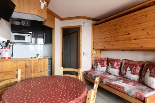 - une cuisine avec une table et un canapé dans une chambre dans l'établissement Résidence Chamois - Studio pour 4 Personnes 134, à La Plagne Tarentaise