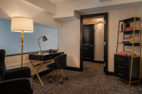 a hotel room with a desk and a mirror at The Manhattan Club in New York