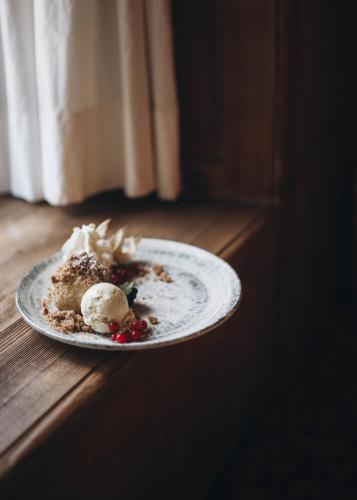 a plate of food with ice cream on a table at Gasthof Post in Dalaas