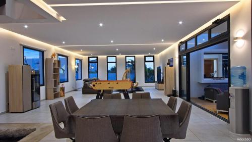 a dining room with a ping pong table in a house at La Villa Phoenix in Saint-Pierre