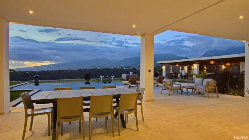 a table and chairs on a patio with a view at La Villa Phoenix in Saint-Pierre
