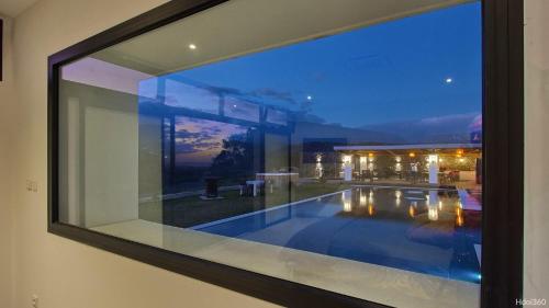a glass window of a house with a swimming pool at La Villa Phoenix in Saint-Pierre