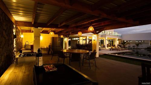a patio with a table and chairs and a kitchen at La Villa Phoenix in Saint-Pierre