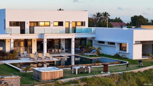a large white house with a swimming pool at La Villa Phoenix in Saint-Pierre