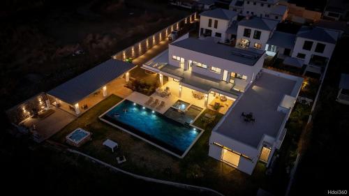 an overhead view of a house with a swimming pool at night at La Villa Phoenix in Saint-Pierre