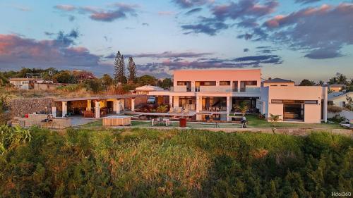 a house on a hill with a sunset at La Villa Phoenix in Saint-Pierre