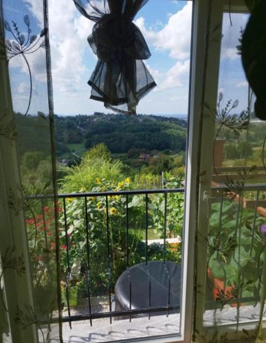 a window with a view of a garden outside at Studio apartman Karmen in Varaždin Breg