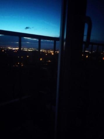 a view of a city at night from a window at Studio apartman Karmen in Varaždin Breg