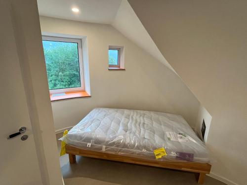 a bed in a room with a window at FlaKturm Wertheim in Wertheim