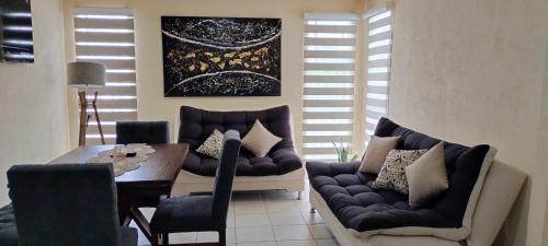 a living room with a couch and a table and chairs at Meraki in Guadalajara