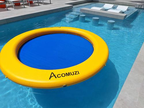 a yellow inflatable raft in a swimming pool at Beachside 2 Bedroom Villa with Pool and Resort Amenities - White Villas - v7 in Providenciales