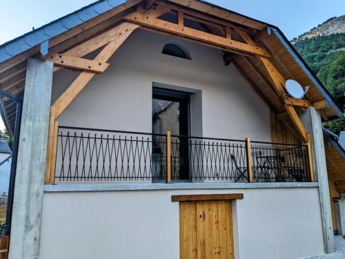a balcony of a house with a wooden roof at Gîte Le Cerbillona- Gavarnie, France in Gavarnie