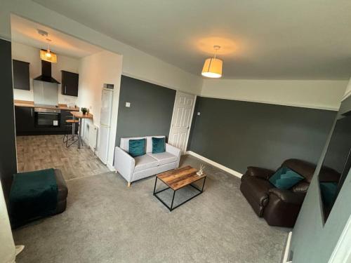 a living room with a couch and a table at 2 Bed Flat Wallsend in Willington Quay