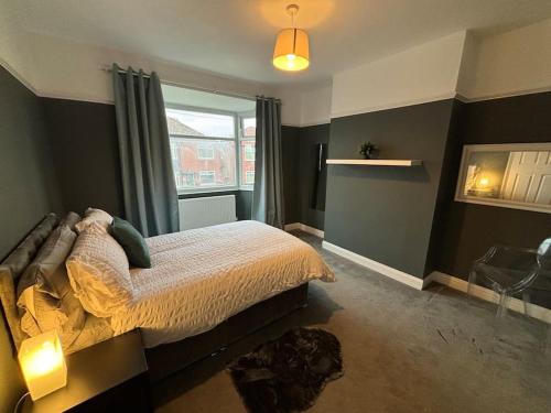 a bedroom with a large bed and a window at 2 Bed Flat Wallsend in Willington Quay