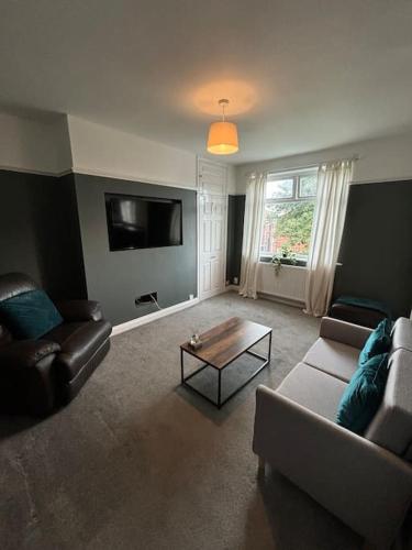 a living room with a couch and a coffee table at 2 Bed Flat Wallsend in Willington Quay