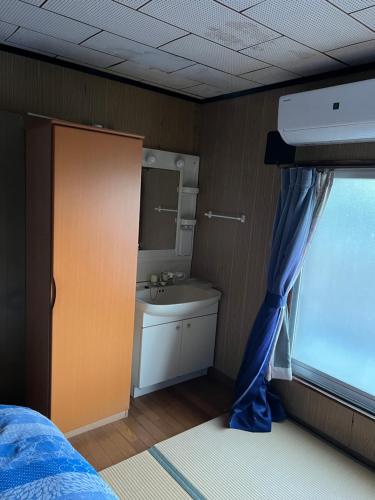 Ein Bett oder Betten in einem Zimmer der Unterkunft 一日限定一組の古民家の宿なんでもん