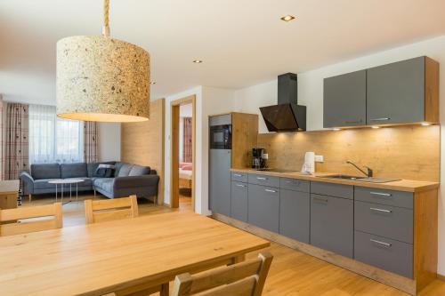 a kitchen and living room with a dining room at Bergzeit - Hotel & Appartements in Oberjoch