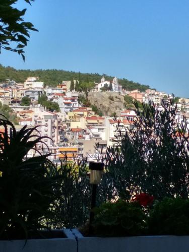 a view of a city with buildings on a hill at Vasilis Garden House in Kavala