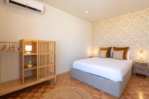 a bedroom with a large white bed in a room at DoisPontoZero Júlio Dinis Gold in Porto