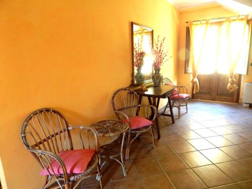 a dining room with a table and chairs and a table at Tenuta Montelaura in Forino