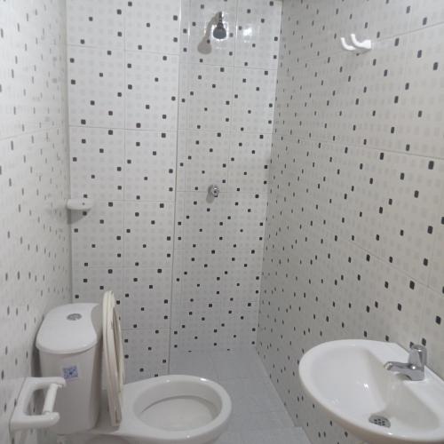 a bathroom with a shower and a toilet and a sink at Cabaña Estuario Capurganá in Capurganá