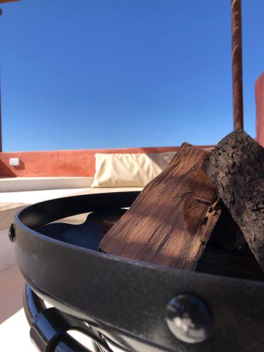 a pan on top of a stove with a wooden spoon at WAYTAY in Cafayate