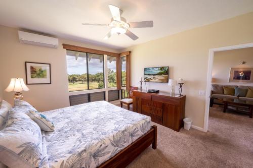 a bedroom with a bed and a ceiling fan at Grand Champions Golf Villas 150 in Wailea