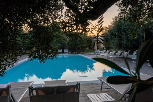 a swimming pool with lounge chairs next to it at Armandiola in Cardedu