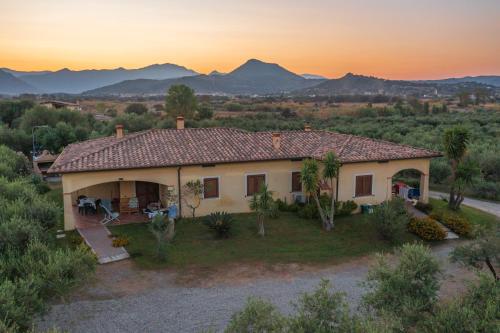 a small house with a sunset in the background at Armandiola in Cardedu