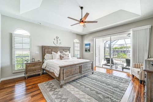 a bedroom with a bed and a ceiling fan at Marco Island Home with Screened Pool Less Than 1 Mi to Beach in Marco Island