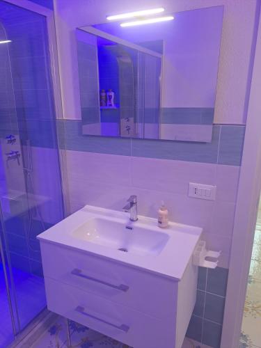 a bathroom with a white sink and a mirror at Citronia Relax in Forio d'Ischia