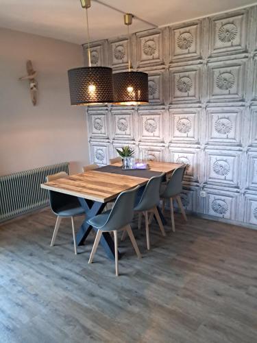 a dining room with a wooden table and chairs at Apartmenthaus Hinterer in Bad Goisern