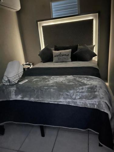 a bedroom with a large bed with a large headboard at Dreamscape in Fajardo