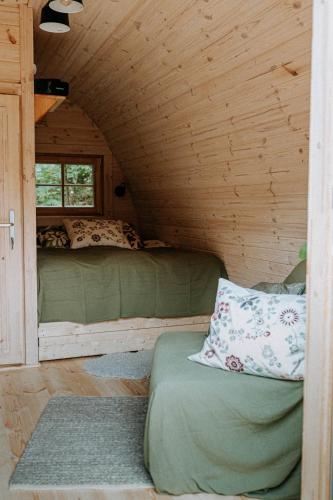 a bedroom with two bunk beds in a cabin at Chata Pod Lasem in Poręba