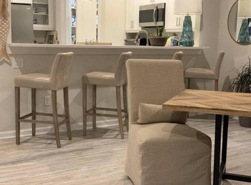 a kitchen with a counter with chairs and a table at Cozy Virginia Beach Vacation Home in Virginia Beach