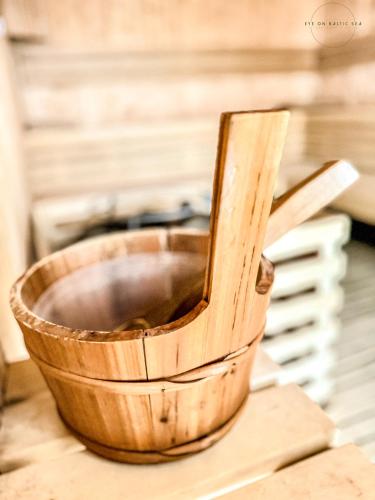 a wooden bowl sitting on top of a table at Brand-New Apartment EYE ON BALTIC SEA Luxurious Spa Escape in Dziwnów with Stunning Views in Dziwnów