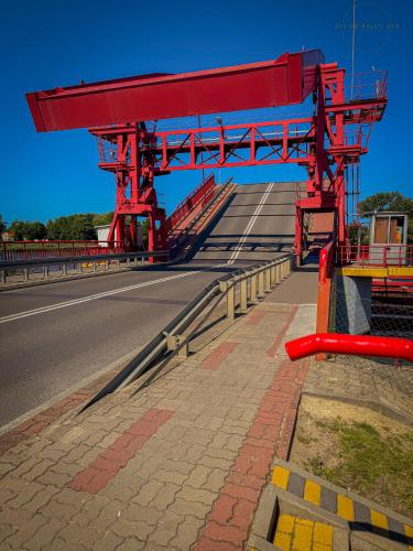 a red structure on the side of a road at Brand-New Apartment EYE ON BALTIC SEA Luxurious Spa Escape in Dziwnów with Stunning Views in Dziwnów