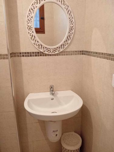 a bathroom with a sink and a mirror at Studio LINA in Hennchir Ksar Rhaleb