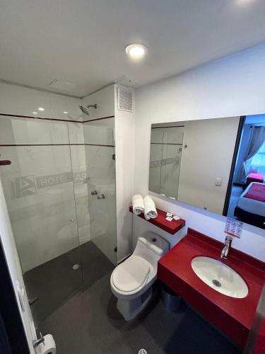 a bathroom with a toilet and a sink and a shower at AW Hotel Ariston in Bogotá