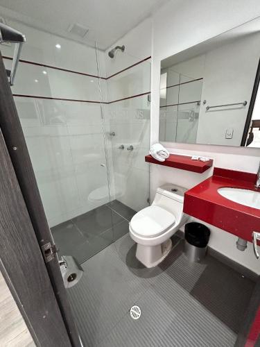 a bathroom with a toilet and a sink and a shower at AW Hotel Ariston in Bogotá