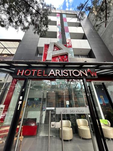 a hotel entrance with chairs in front of a building at AW Hotel Ariston in Bogotá