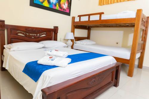 two beds in a room with two bunk beds at Hotel Arce Plaza in Valledupar