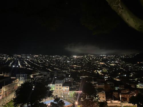 a view of a city at night with lights at AW Hotel Ariston in Bogotá