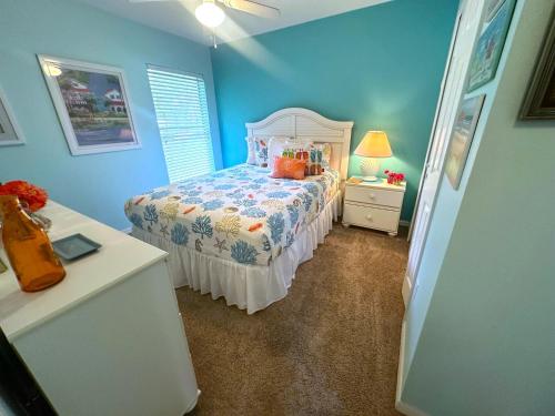a blue bedroom with a bed and a dresser at Upgraded Pool Villa Spa Southern Dunes in Haines City