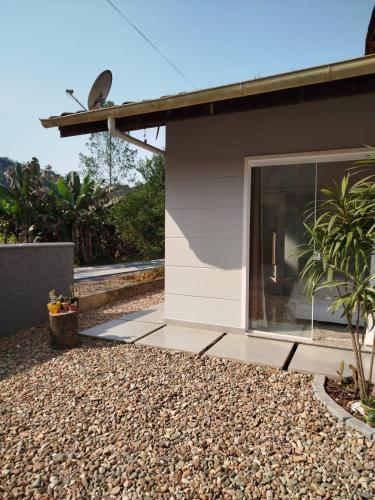 a house with a large window on the side of it at Suítes Garden in Pomerode