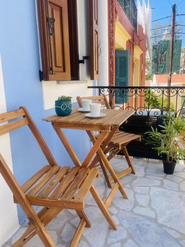 a wooden table and chairs on a balcony at Serenity Luxury Apartment in Symi